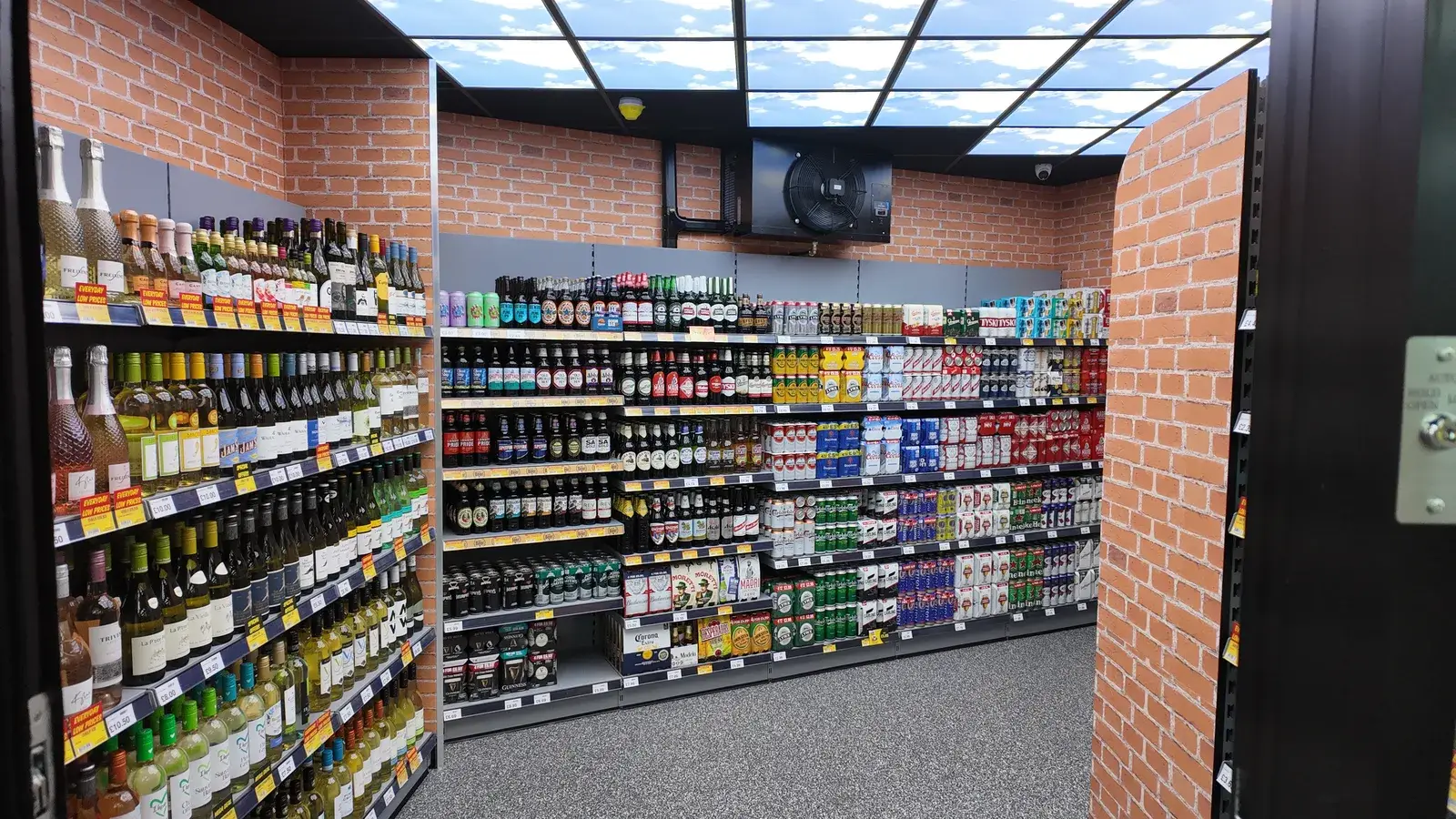 Inside the beer cave — walls stocked floor to ceiling with chilled drinks