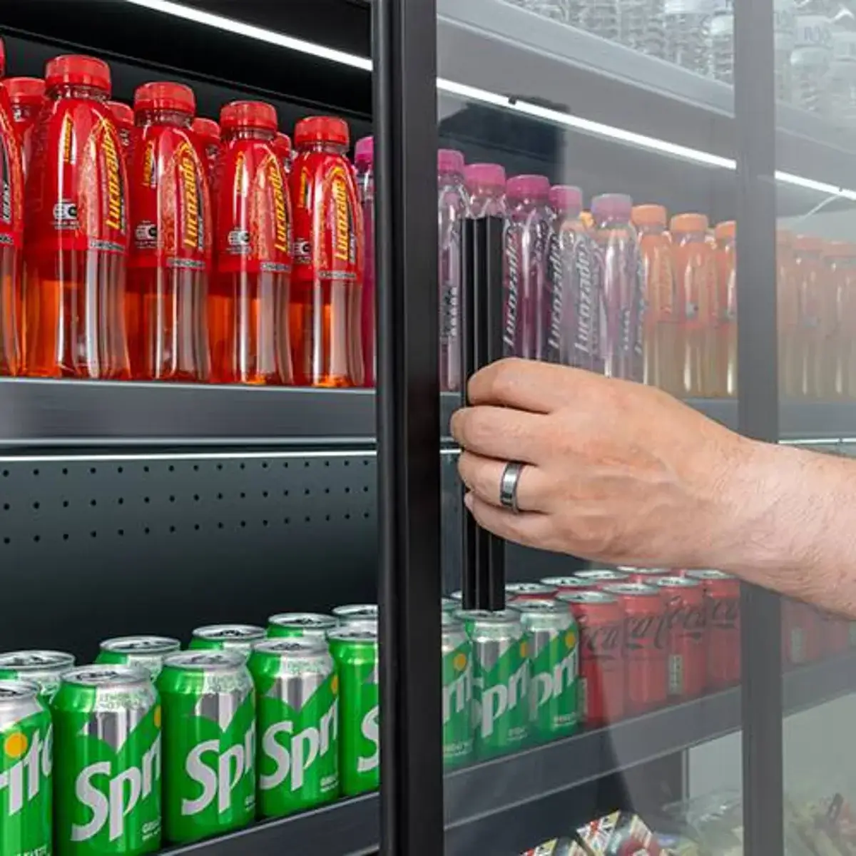 A stocked Blizzard multideck fridge with sliding glass doors, drinks at arm's reach