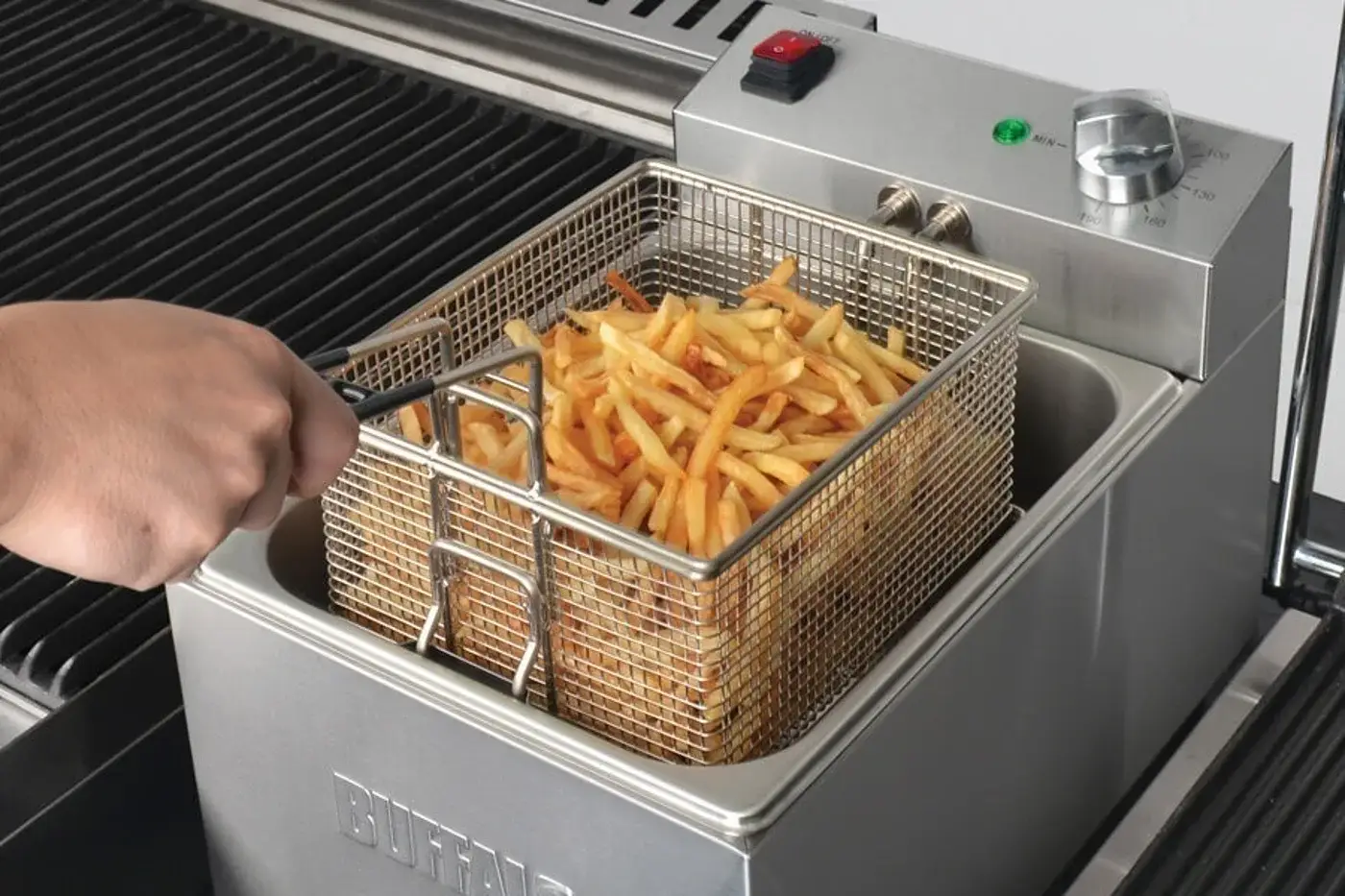 Chips lifted fresh from a Buffalo countertop fryer