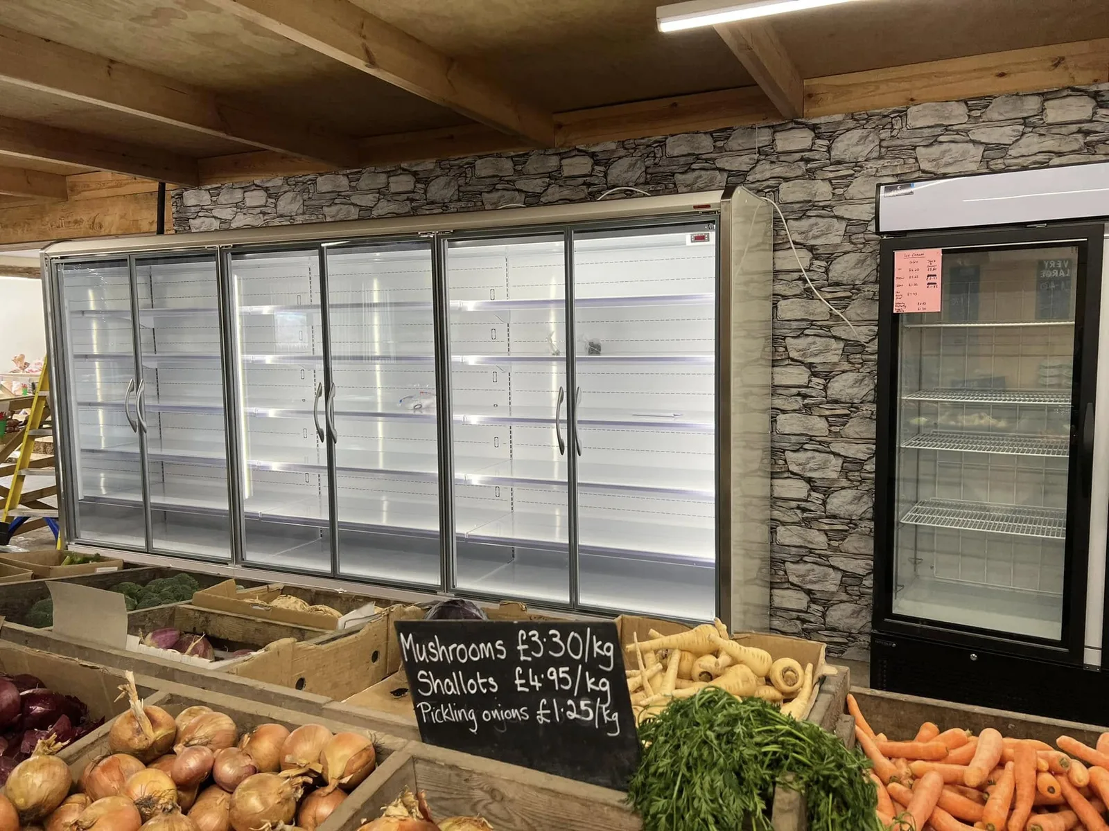 The new multideck fully stocked with fresh vegetables and hand-written price signs