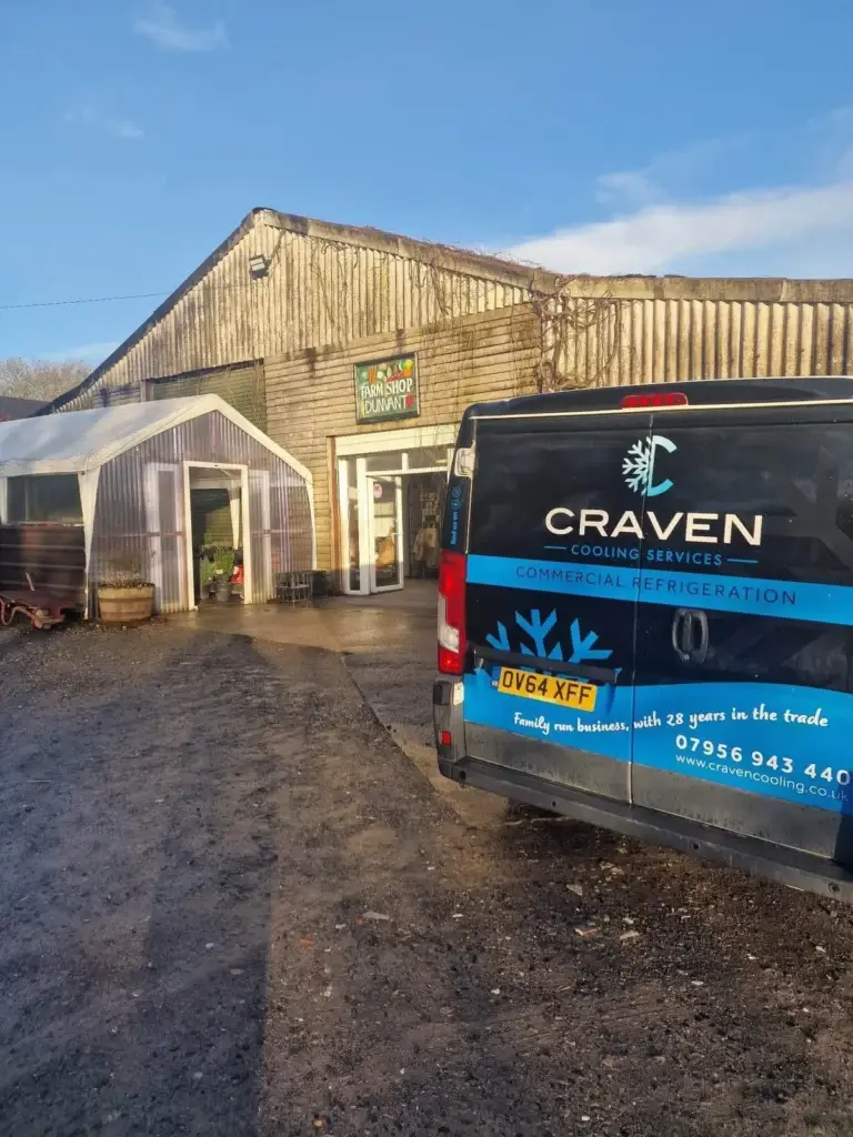 Craven Cooling van parked outside Dunvant Farm Shop's timber-clad buildings under a blue sky
